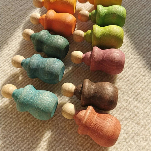 open ended play with wooden peg dolls and stacking toys. Inspire creativity, fine motor skills