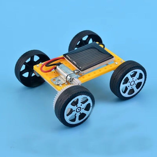 Small model car with wheels and electronic components on a blue background