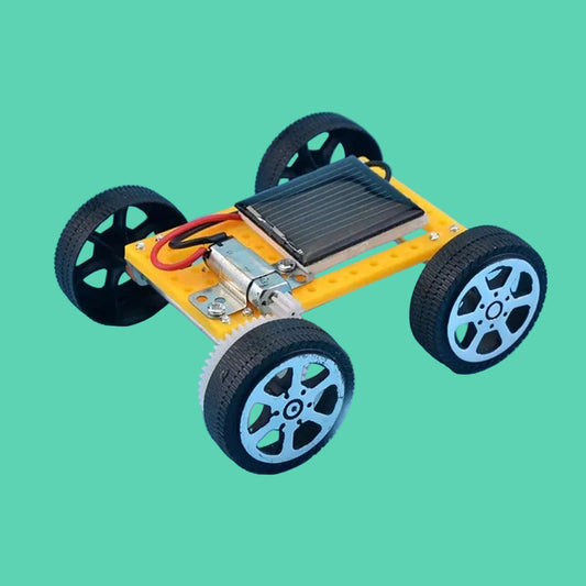 Small model car with wheels and electronic components on a blue background