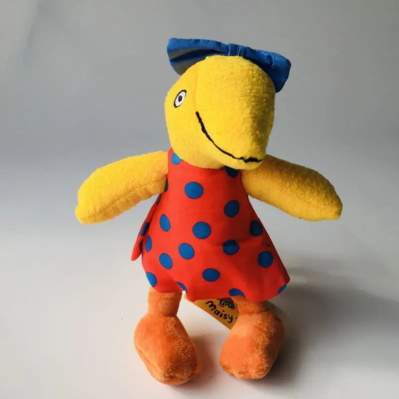 A plush toy bird character with a yellow body, blue bow, red dress with blue polka dots, and orange feet, standing against a plain light gray background.
