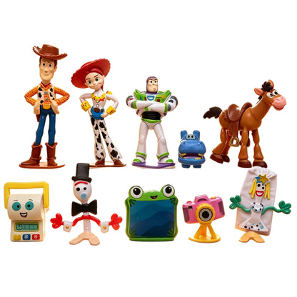 A group of Toy Story-5 themed small figurines and accessories displayed on a clear acrylic stand in a child's bedroom. Visible characters include Woody, Buzz Lightyear, Jessie, Rex, Bull, and several smaller toy figures on the floor.