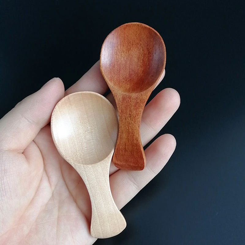 Small wooden spoon made of natural schima superba wood.