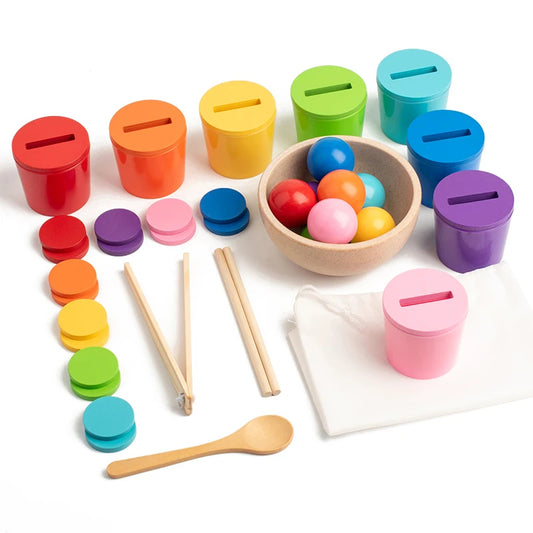 Colorful educational toys including sorting cups, beads, and wooden sticks on a white background