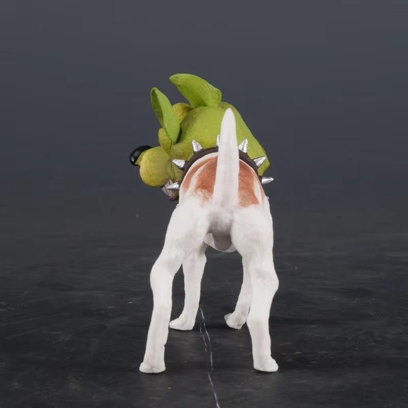 Dog toy resembling a green Milo the Mask Dog Figurine with a spiked collar on a dark background