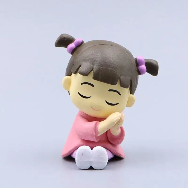 monster university mini collectible toys of a girl with pigtails in a pink dress on a light gray background