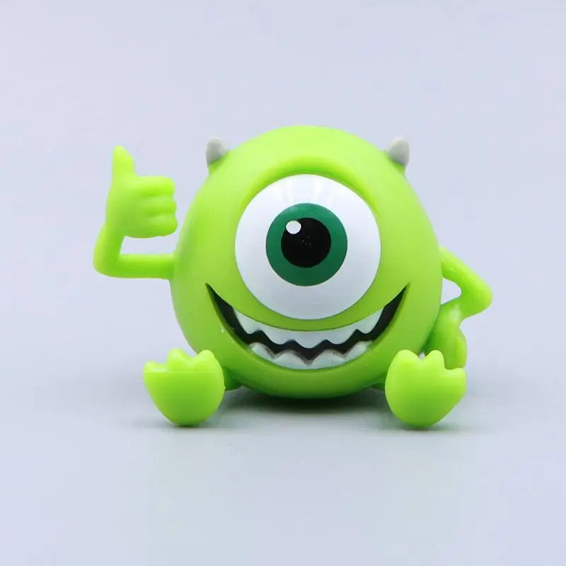 monster university mini collectible toys  with a large eye and a thumbs-up gesture on a light gray background