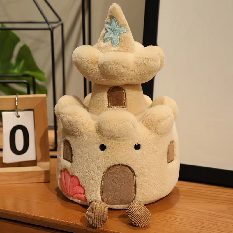 Plush toy resembling a Sand castle with a star on top, placed on a wooden surface.