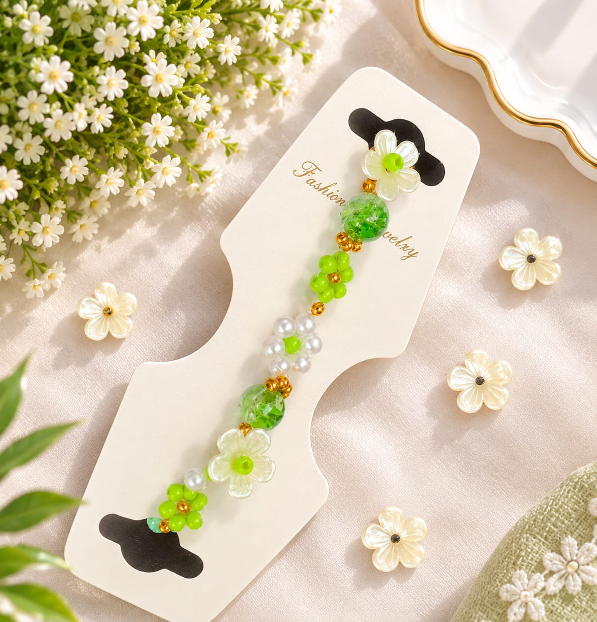 A beaded Bracelets For Women on a white card, featuring green beads, white flower beads, and small gold accents, styled with small white flowers on a soft beige fabric background.