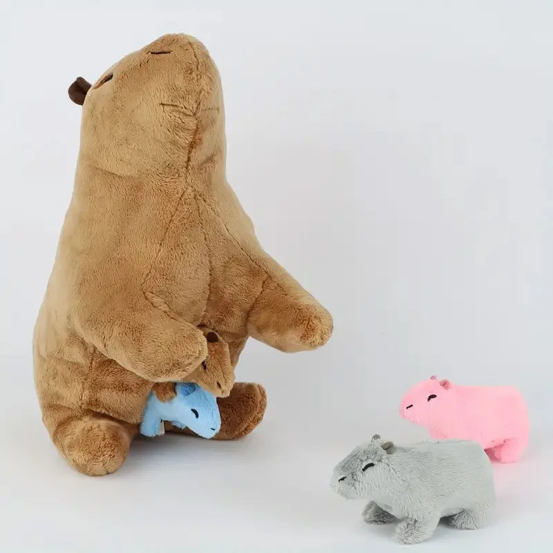 Brown plush bear with smaller blue, pink, and gray plush animals on a white background