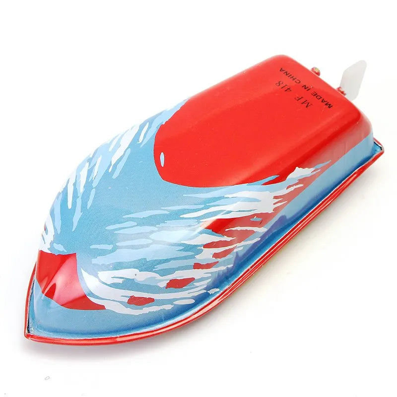 Toy boat with red top and blue body on a white background