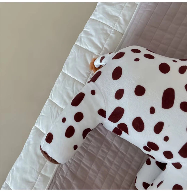 White sleeve with brown polka dots on a neutral background
