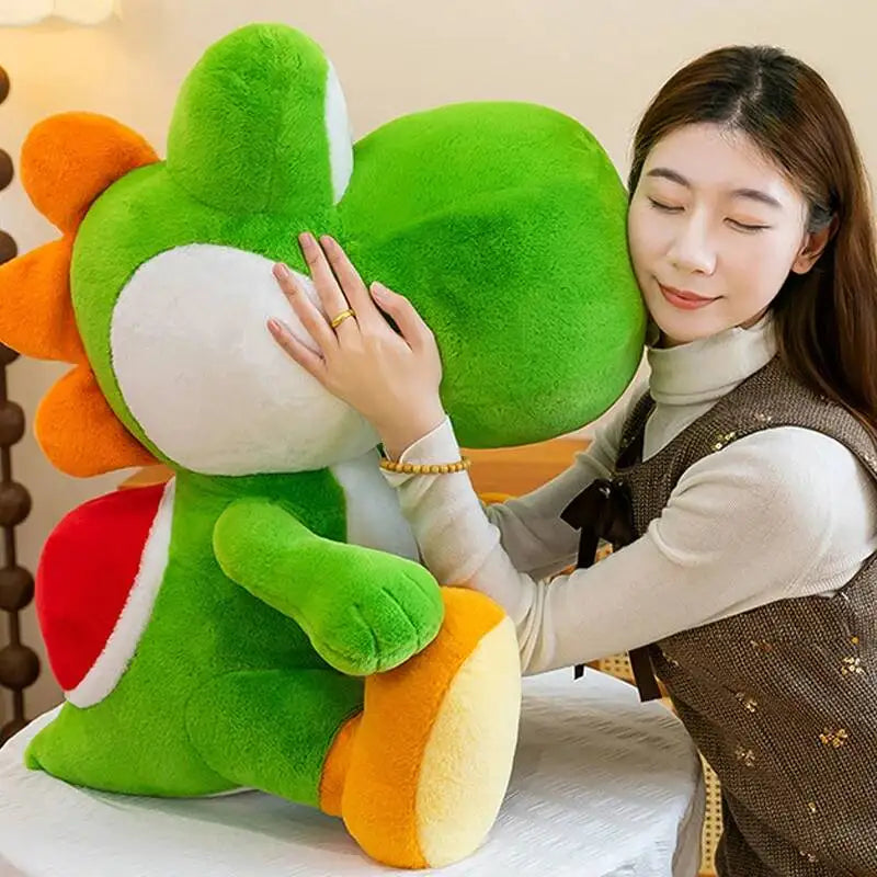Person holding a large yoshi plush toy with orange and red accents