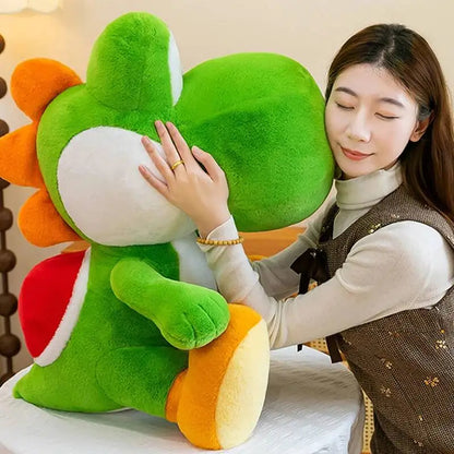 Person holding a large yoshi plush toy with orange and red accents